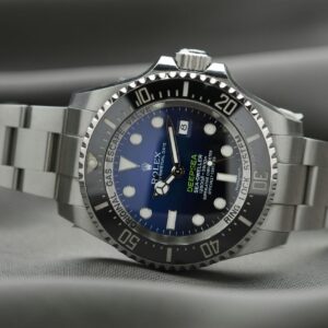 A Rolex Deepsea watch with a blue dial and a stainless steel bracelet laying on its side.